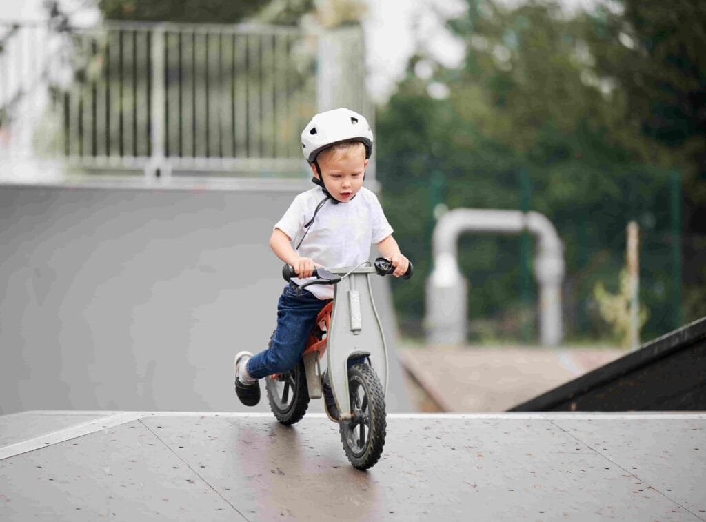 A toddler riding an electric balance bike