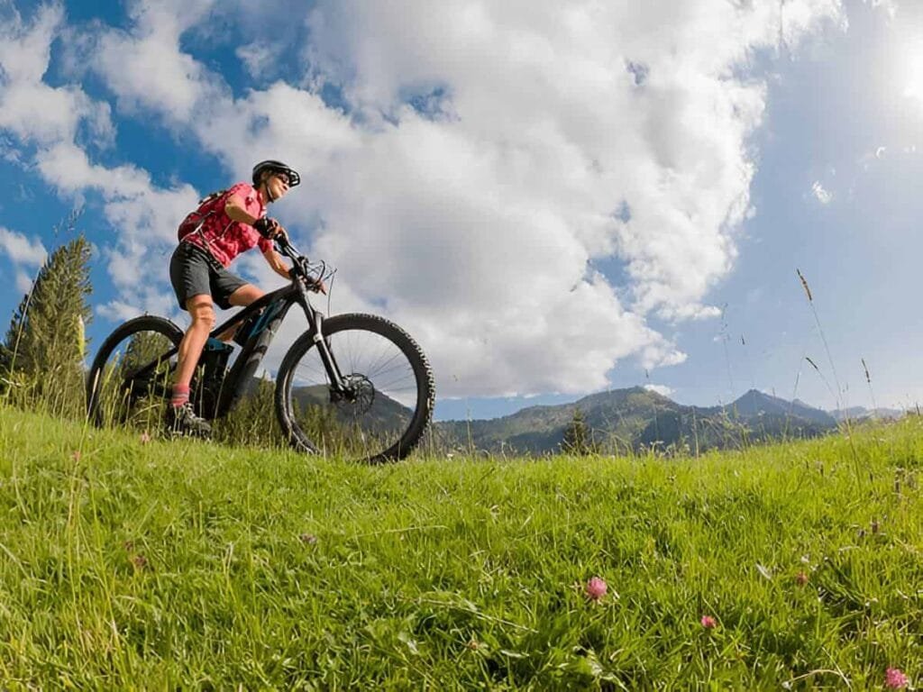 A person is riding a mountain bike on hilly terrain