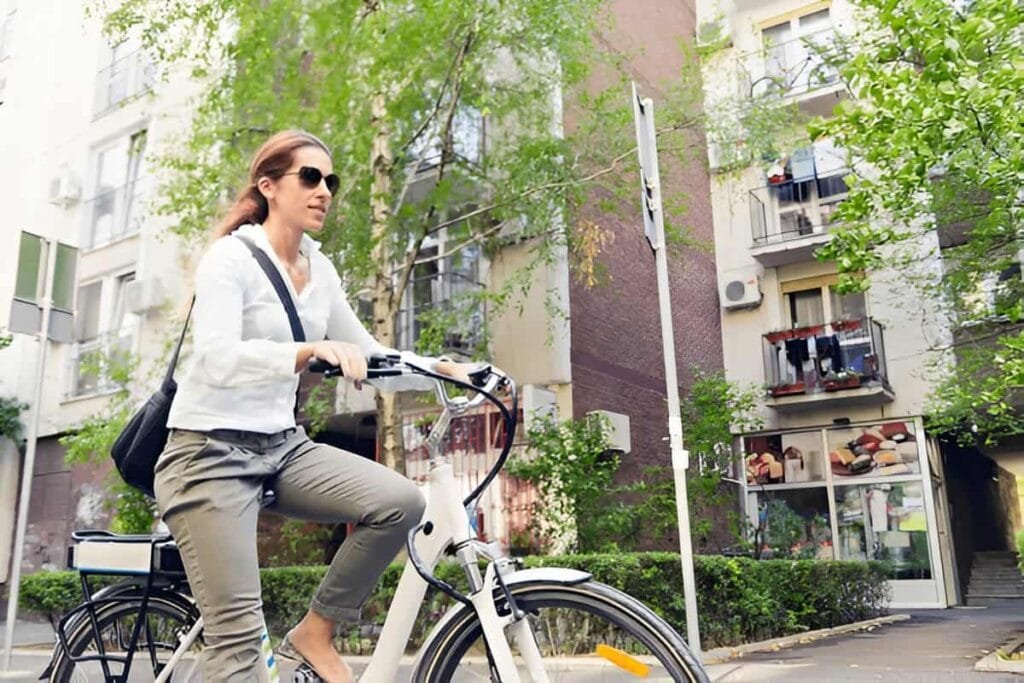 A woman commuting on a ancheer electric bike on a city street