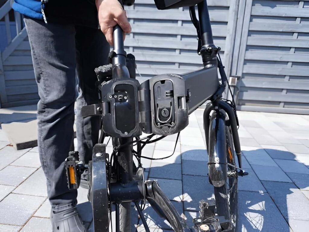 A person showing Jetson electric bike folding